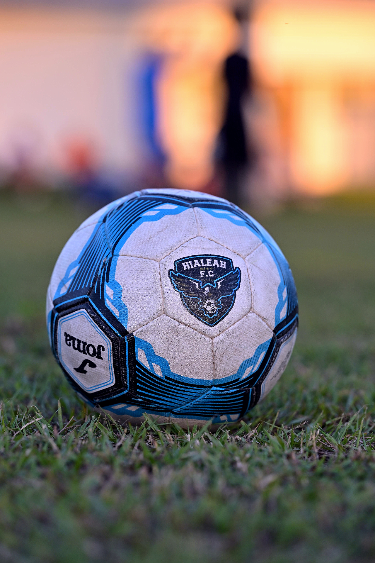 Hialeah City FC ball on the field at sunset.
